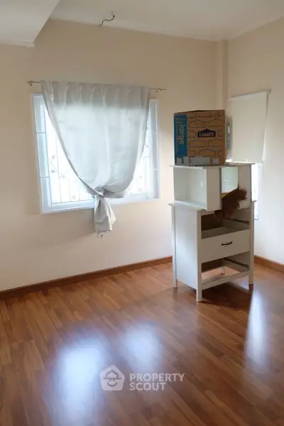 Spacious room with wooden flooring and natural light, ideal for versatile use.