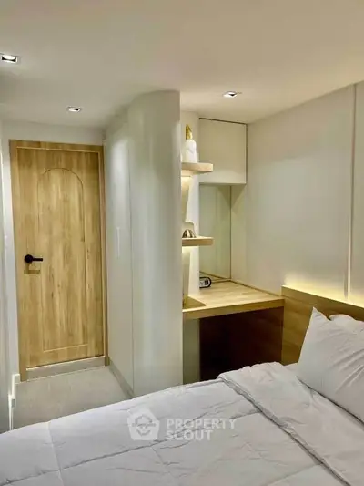 Cozy modern bedroom with built-in study nook and wooden door