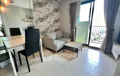 Modern living room with stylish decor and balcony access in a contemporary apartment.