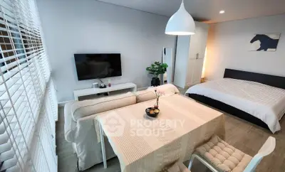 Modern studio apartment with cozy living area and stylish decor