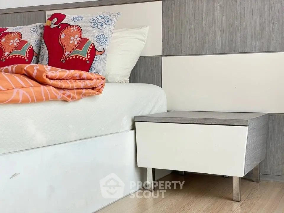 Modern bedroom with stylish side table and vibrant pillows