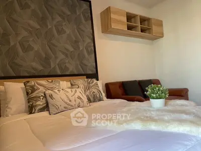 Cozy bedroom with stylish decor and comfortable seating area