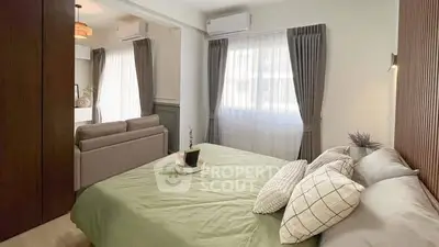 Modern bedroom with stylish decor and natural light, featuring a cozy bed and elegant curtains.