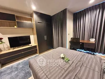 Modern bedroom with stylish decor, featuring a cozy bed, sleek wardrobe, and a functional study desk.