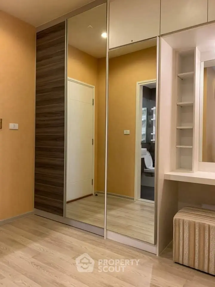 Modern bedroom with mirrored wardrobe and sleek design