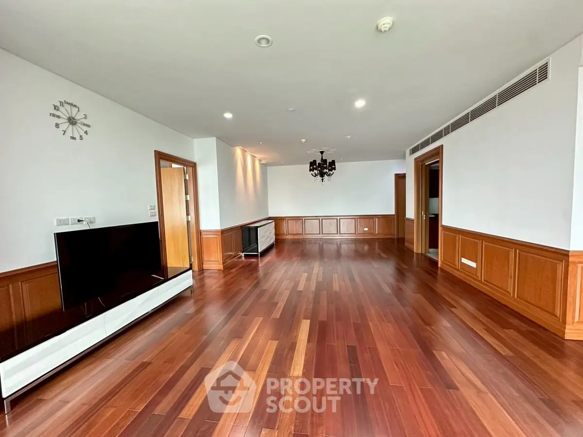 Spacious living room with elegant wooden flooring and modern decor