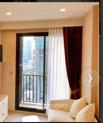 Modern living room with city view and balcony access in high-rise apartment