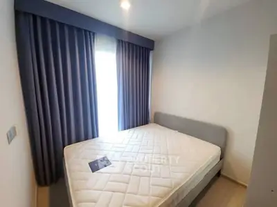 Cozy bedroom with modern design and large window for natural light