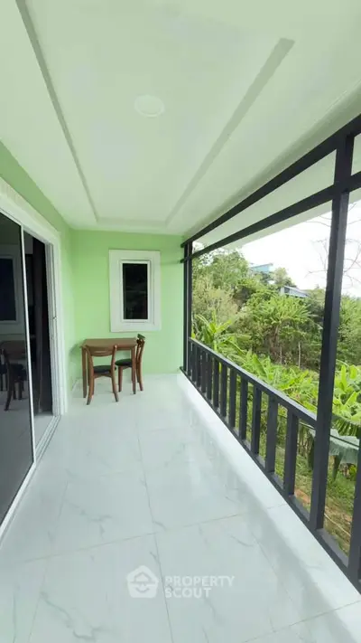 Spacious balcony with scenic garden view and elegant tiled flooring