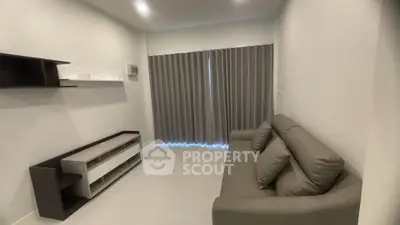 Modern living room with sleek furniture and large window with curtains