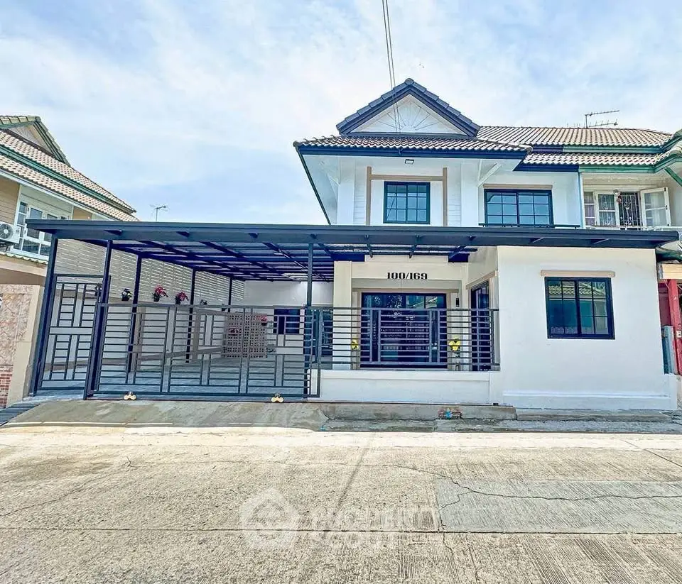 Charming two-story house with modern carport and spacious driveway in a serene neighborhood.