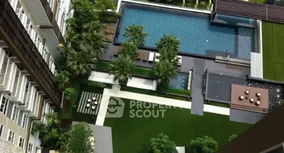 Luxurious aerial view of modern apartment pool and lush garden area.