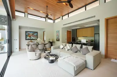 Luxurious open-plan living room with modern decor and high ceilings, featuring a spacious seating area and elegant dining space.