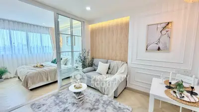 Modern studio apartment with cozy living area and stylish bedroom, featuring elegant decor and natural light.