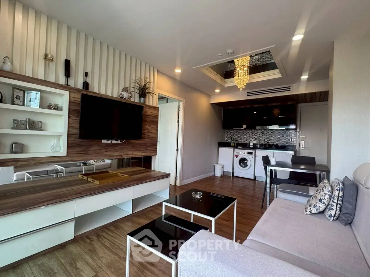 Modern living room with open kitchen, stylish decor, and washing machine