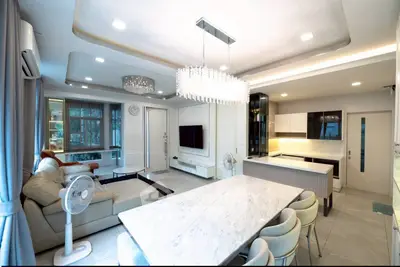 Luxurious open-plan living room with modern kitchen and elegant chandelier