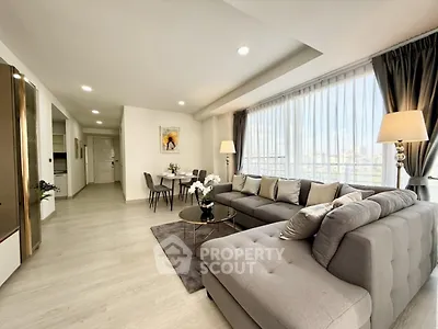 Spacious modern living room with large windows and elegant decor