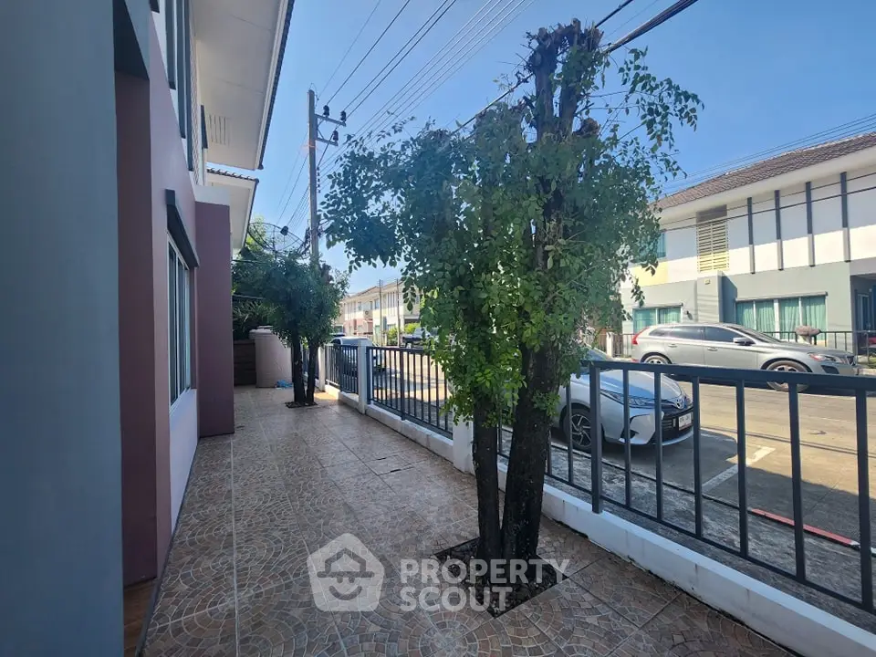 Charming residential street view with tree-lined sidewalk and modern houses