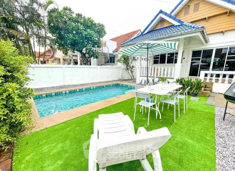 Charming backyard with pool and outdoor dining area in cozy residential home.