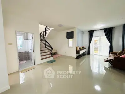 Spacious modern living room with glossy floors and elegant staircase
