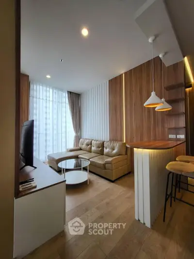 Modern living room with stylish decor, featuring a cozy sectional sofa and elegant lighting.