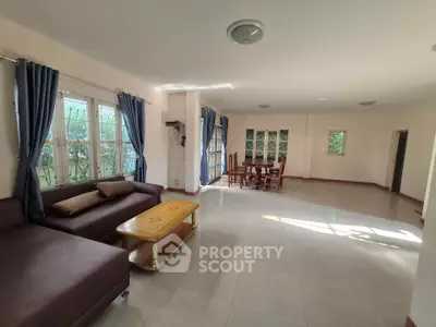 Spacious living room with elegant furniture and large windows for natural light.