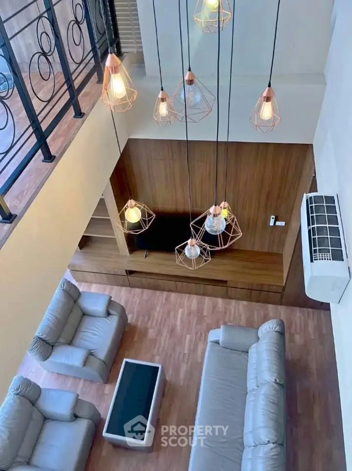 Stunning loft-style living room with modern lighting and elegant furnishings.