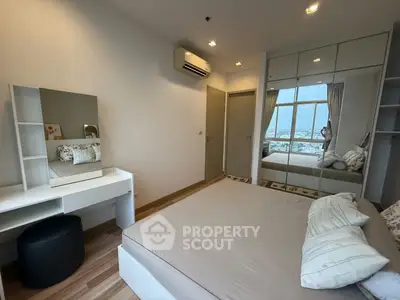 Modern bedroom with mirrored wardrobe and city view