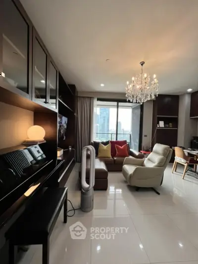 Luxurious living room with chandelier and city view, modern furniture and elegant decor.