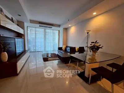 Spacious modern living room with elegant decor and large windows offering natural light.