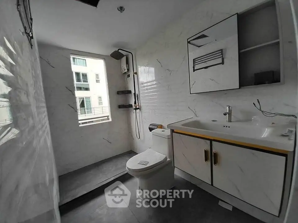 Modern bathroom with sleek fixtures and large window for natural light.