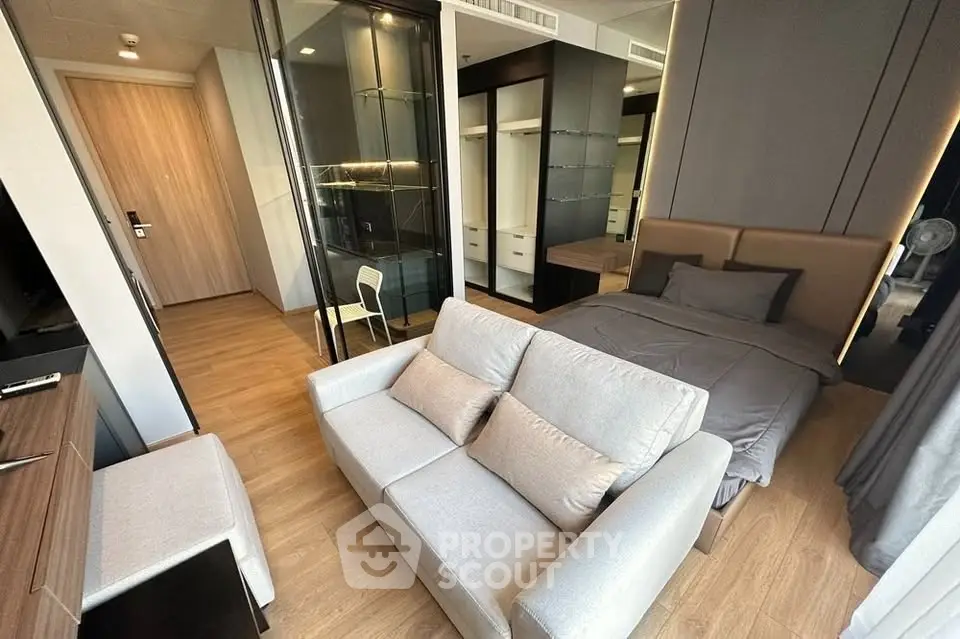 Modern studio apartment with cozy living area and stylish bedroom design.