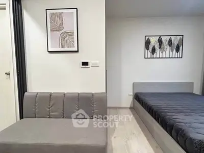 Modern bedroom with stylish decor and cozy seating area
