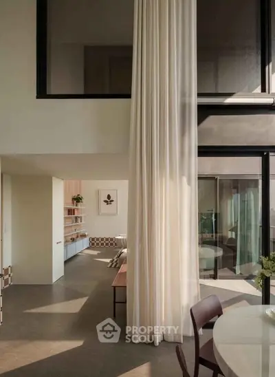 Spacious modern living room with high ceilings and elegant decor