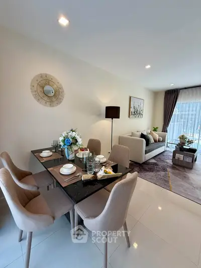 Elegant living and dining area with modern decor and natural light