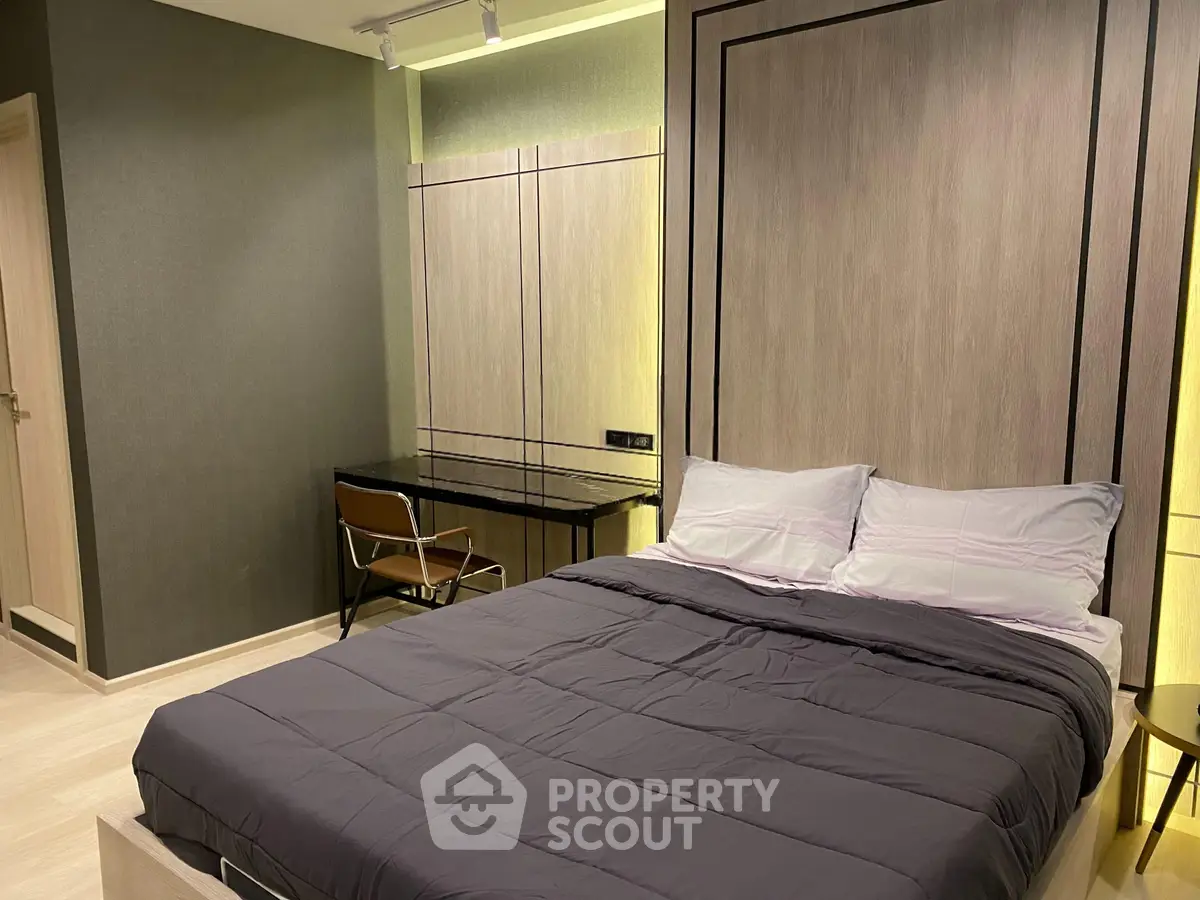 Modern bedroom with stylish decor and cozy ambiance, featuring a comfortable bed and sleek furniture.