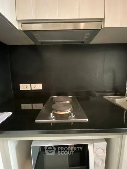 Modern kitchen with sleek black countertop and electric stove