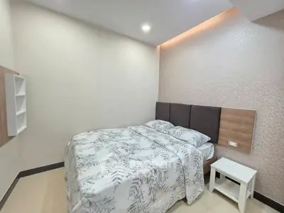 Cozy bedroom with modern decor and comfortable bedding in a stylish apartment.