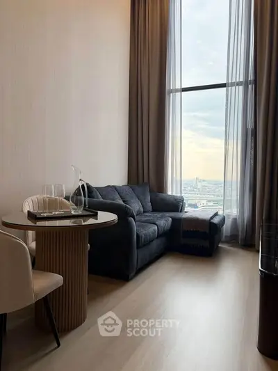 Modern living room with large window and city view, featuring stylish furniture and elegant decor.
