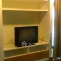 Cozy living room with built-in shelving and TV setup
