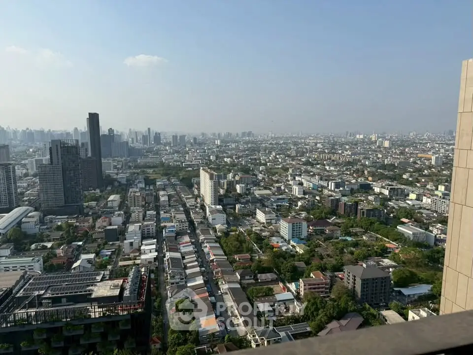 Stunning cityscape view from a high-rise building showcasing urban skyline and residential areas.