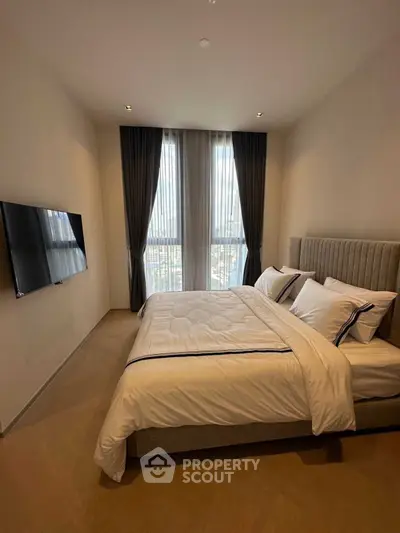 Luxurious bedroom with modern decor and large window view