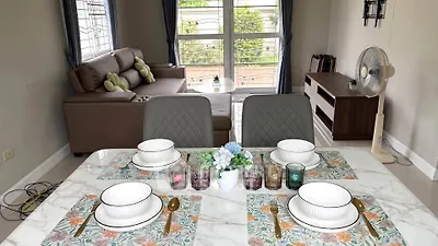 Charming living room with elegant dining setup and cozy seating area, perfect for entertaining.
