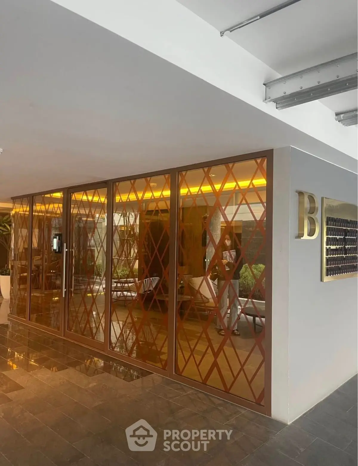 Modern building entrance with stylish glass facade and elegant lighting