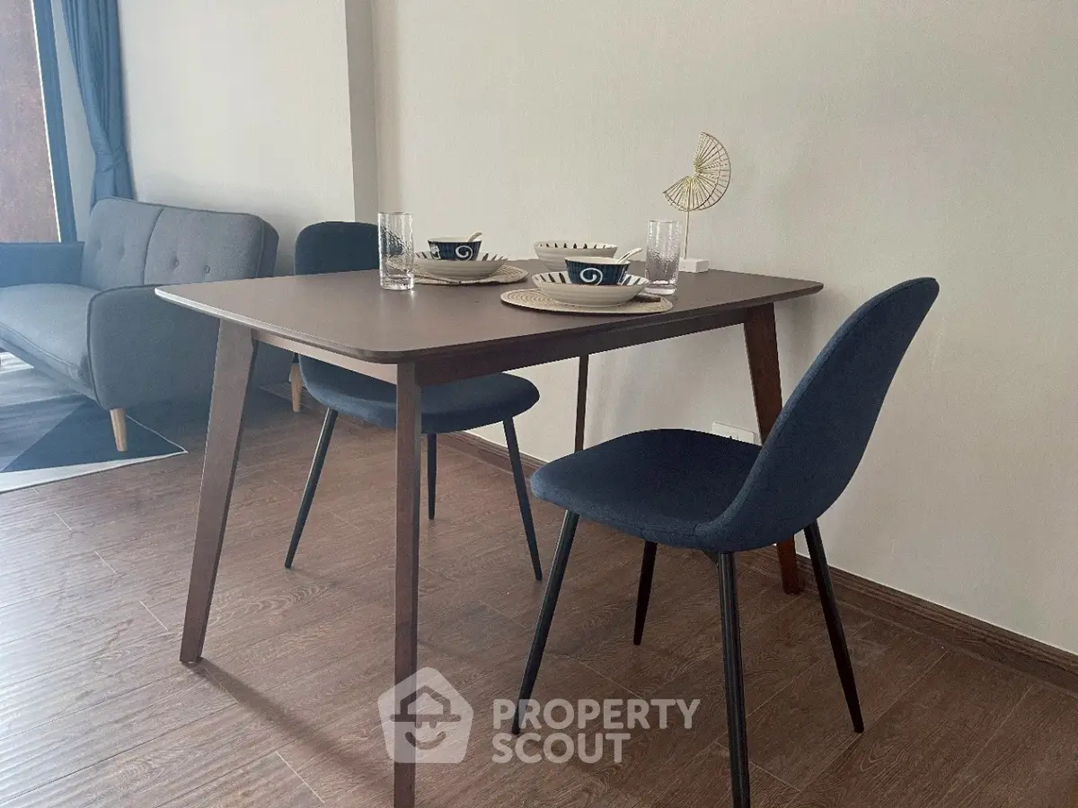 Modern dining area with stylish table and chairs in a cozy living space.