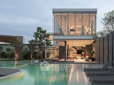 Luxurious modern home with stunning glass architecture and poolside view