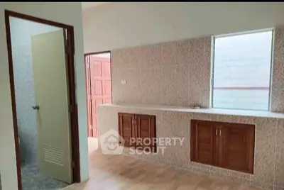 Spacious kitchen with wooden cabinets and ample natural light