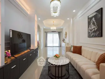 Luxurious living room with elegant decor, modern chandelier, and spacious layout.