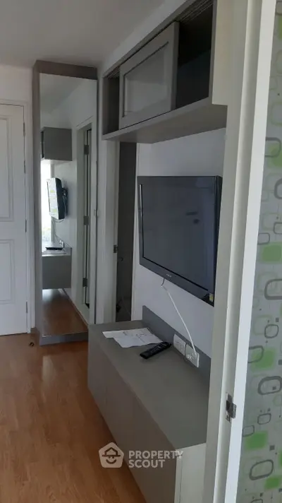 Modern living room with sleek TV setup and stylish storage solutions.