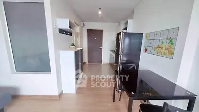 Modern apartment interior with sleek kitchen and dining area, featuring stylish decor and ample natural light.